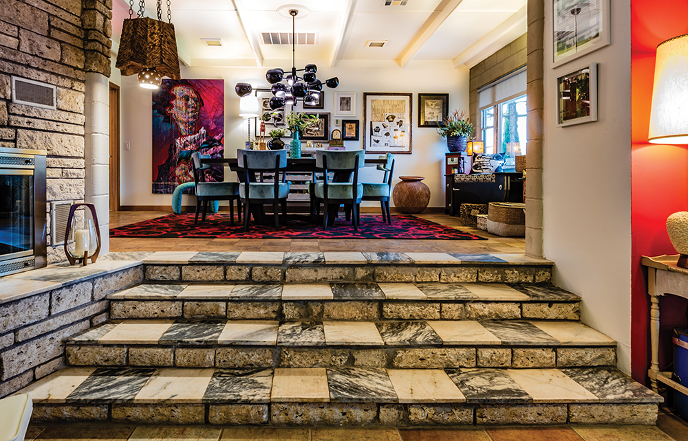Austin fossil rock surrounds the fireplace. In the dining room, the home’s original wood floors are topped by one of Artus’s elegantly wacky finds: a rug with a pattern of bicycles. A large piece by Norman artist Stuart Whitis anchors one side of the wall, and at the other side hangs a framed sketch by Artus’s grandfather, who was a cattle rancher.