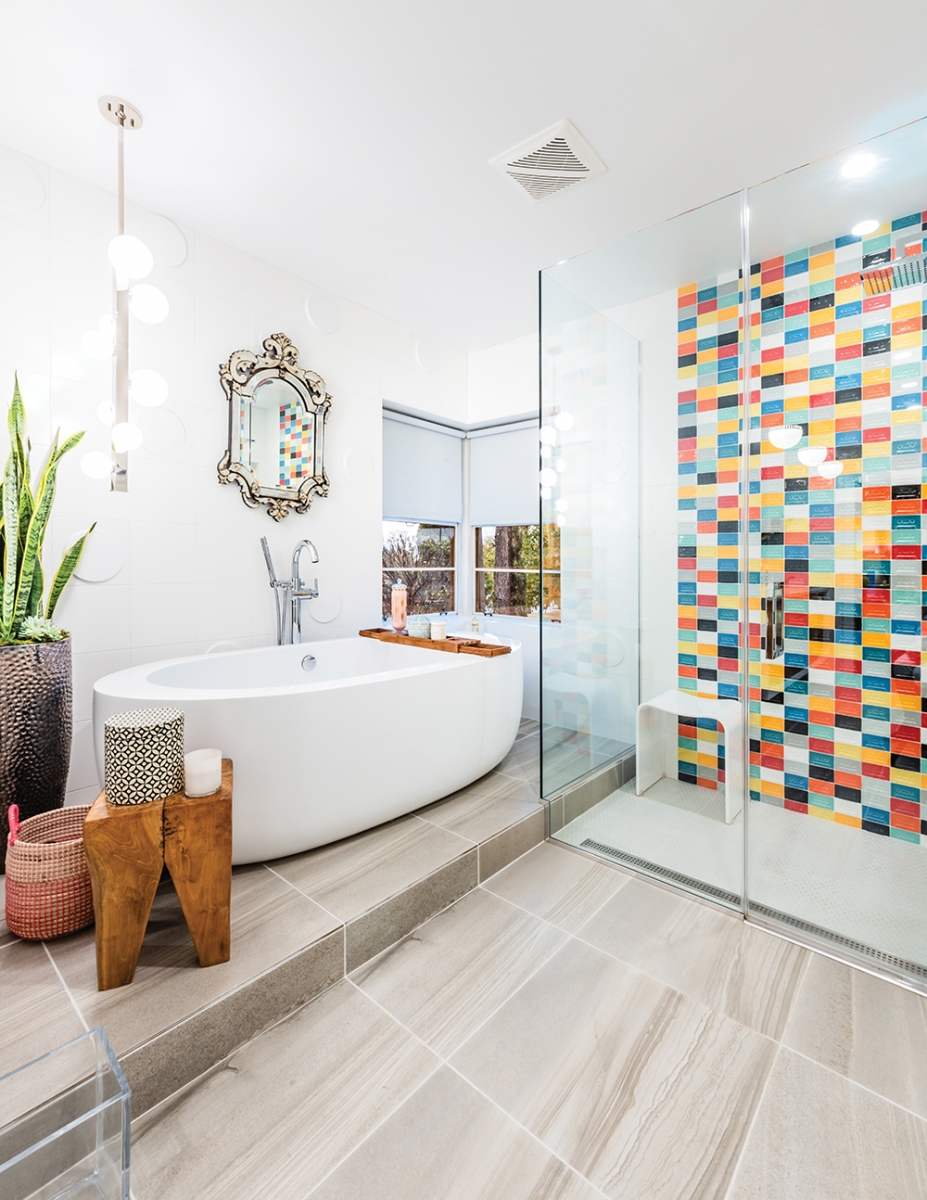The couple knocked out walls and took over a bedroom to create a larger, brighter master bath. The multi-colored tiles in the shower are shaped like cassette tapes, and a bright white, bean-shaped soaking tub is a great spot to escape the worries of the day. “This room was painted light blue, with burgundy tile, low sinks and a dark tub. I started every day pissed. Now, every day starts out with endless possibilities,” Artus says.