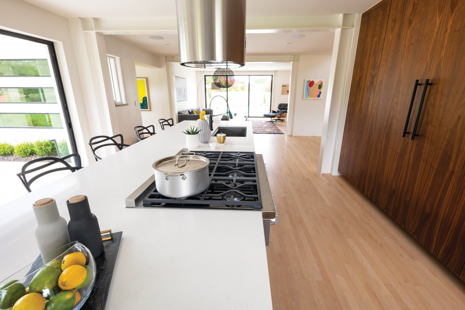 Natural light floods the kitchen, and the palette of beautiful natural materials is carried into this space, as well. The Jones family often takes meals here at the counter, adding convenience to their daily routine.