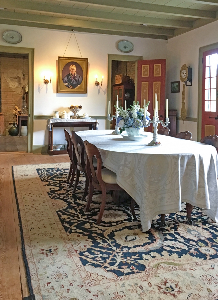 An 1850 portrait of Nanette Prud’homme Duparc watches over the dining room at Laura.