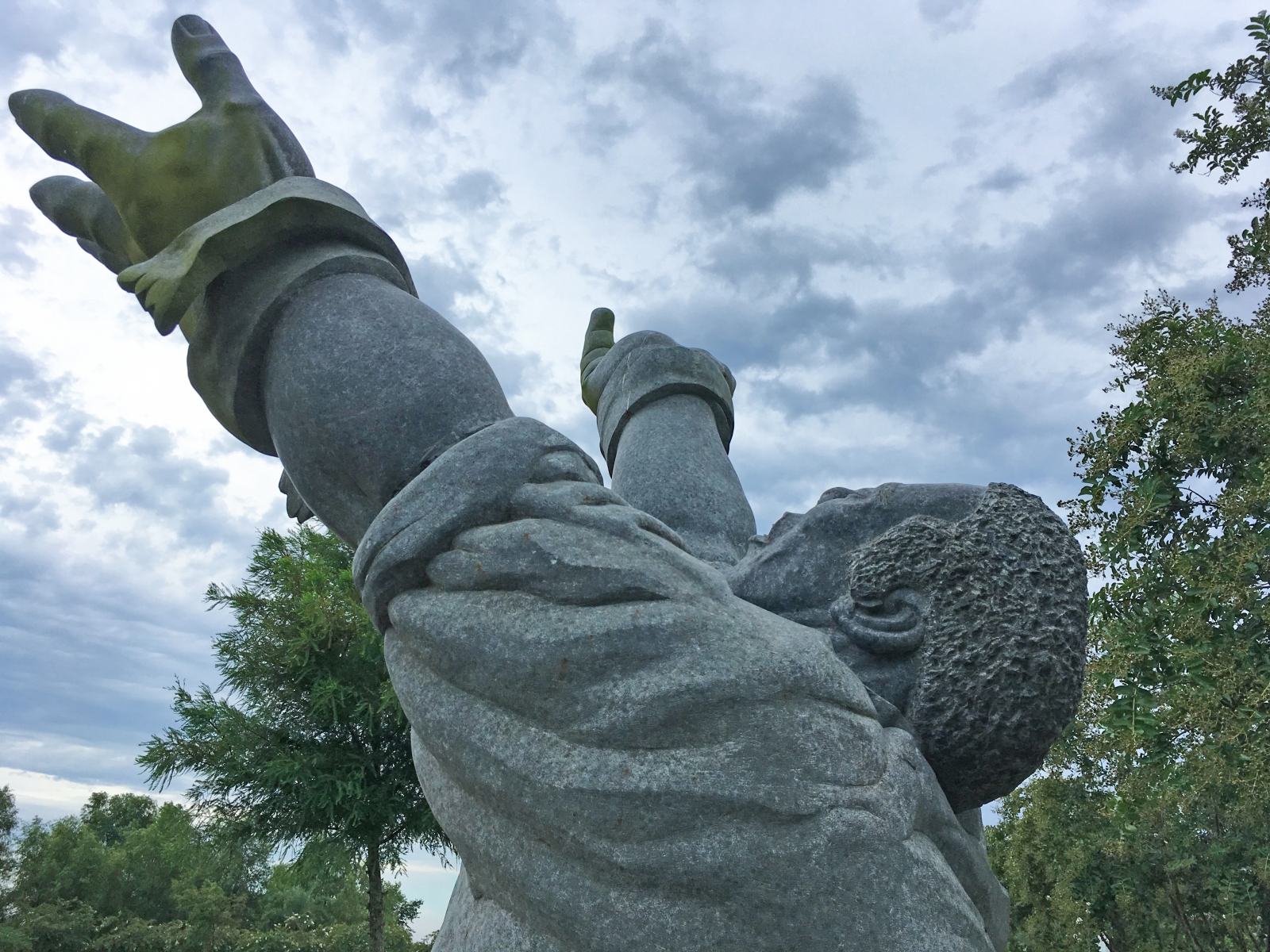 “Hallelujah,” a large, black, soapstone sculpture by Ken Smith, stands on the grounds of Whitney Plantation.