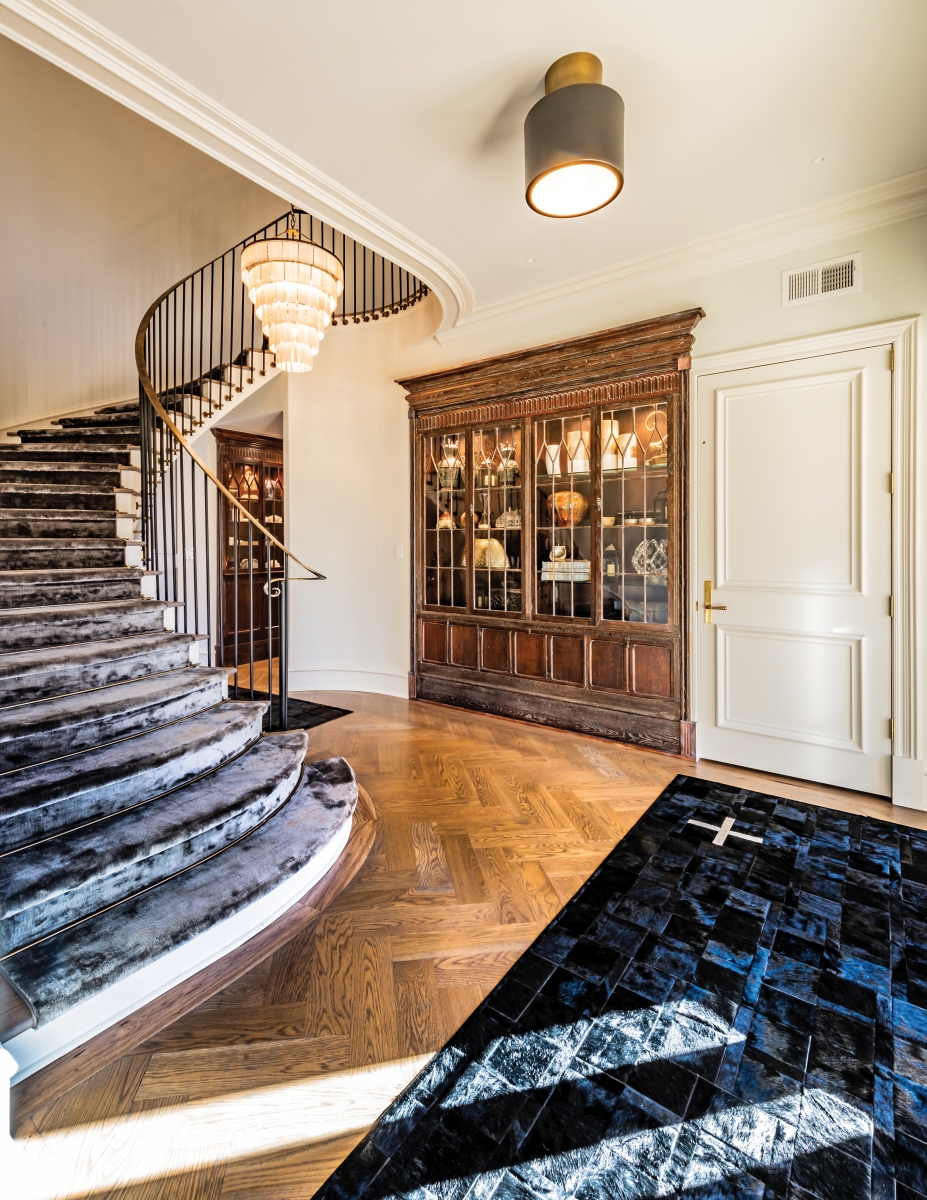 A six-tier shale chandelier and new wrought iron work on the original stairs make the Burrage home’s foyer a grand entrance. The carpet on the stairs is silk and wool, and the built-in wood cabinet that was original to the house was meticulously moved from a hallway around the corner.
