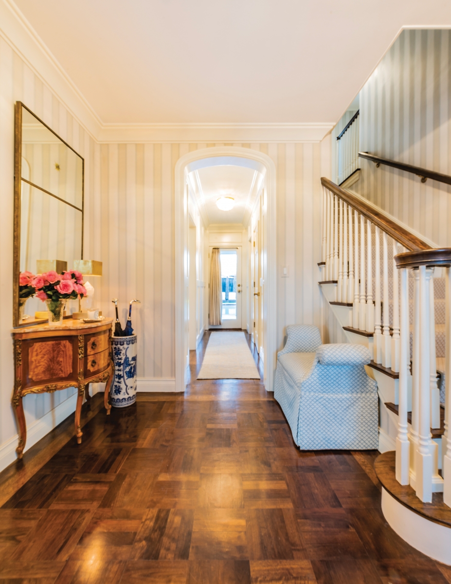 Parquet floors, original to the Bankhead home in Nichols Hills, greet visitors as they have for nearly a century. Wallpaper in a calm neutral stripe and select furnishings – a quietly upholstered bench, gilt- and marble-inlaid Louis XV-style console and beautiful ginger-jar-style umbrella stand – keep a traditional feel in a house that’s been in the family for generations.