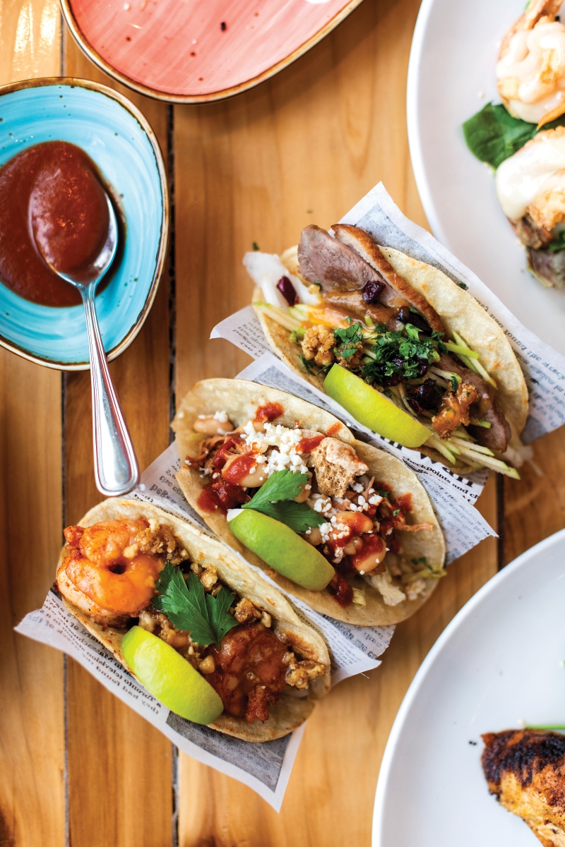 A taco trio spanning walnut shrimp, pulled pork and tender duck confit