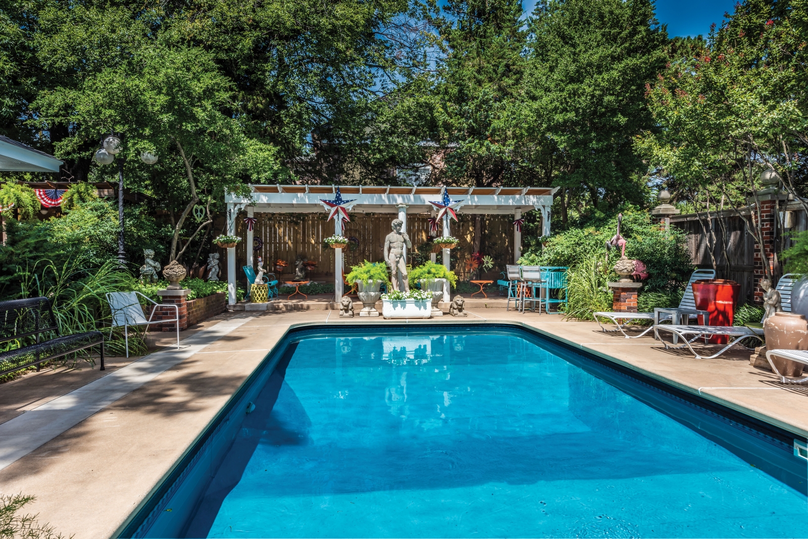 The couple added a pool to the backyard, and the outdoor living area is decorated with vintage patio furniture from the 1950s and 1960s