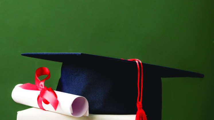 Books, Academic Cap And Diploma On Wooden Surface Isolated On Gr