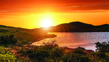 A Bright Orange Crimson Sunset In The Valley Of Wichita Mountain