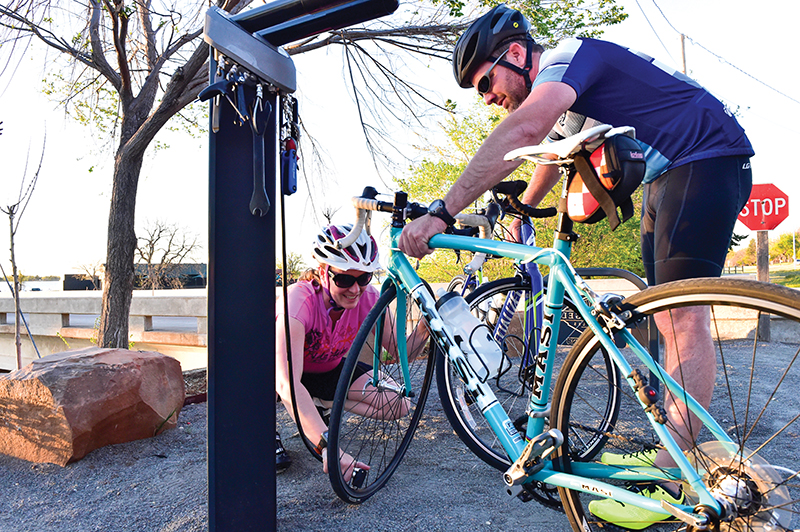 Riders stop for a tuneup at a cycle aid station.