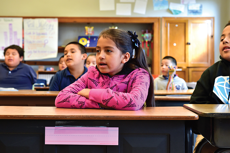 Third-grade children (right) at Shidler Elementary receiving language instruction from their teacher.