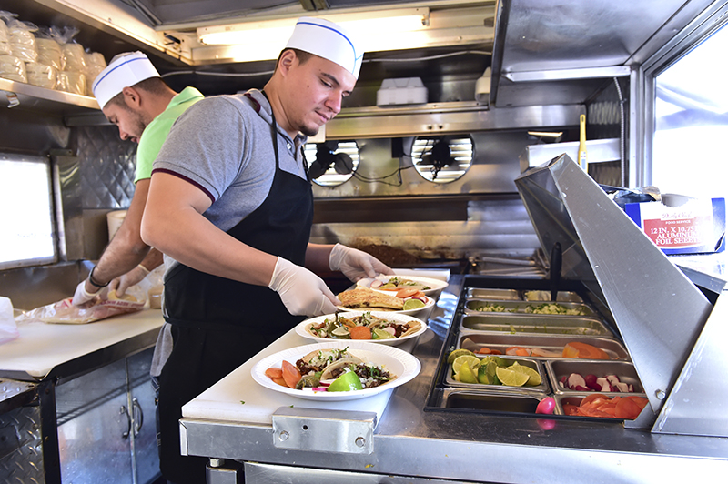 Diego Pelayo and manager Jose Pelayo Naranjo preparing street tacos for the lunch crowd in the Mister Dolar truck on SW 29th near Western.