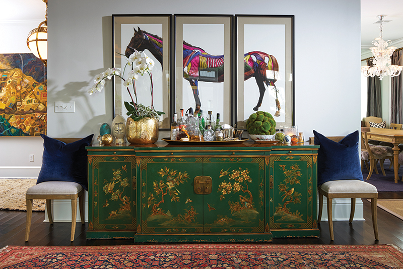 Throughout the home, Heather and Keith have mixed finds from Etsy, Cherish and eBay with treasures from favorite local purveyors including Urbane, Sara Kate Studios and 30A Home. The triptych above the spectacular, hand-painted, 19th century chinoiserie buffet is an eBay score. Beautiful potted orchids add drama, while a collection of glass eggs is a nod to the couple’s Good Egg Dining Group.