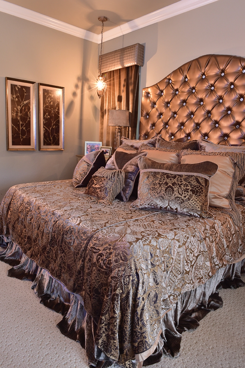 Neese worked with a designer to create custom window treatments for her new nest. In her bedroom sanctuary (above), neutrals steal the show. A dozen throw pillows of all sizes and a tufted headboard add drama. Twin hanging sconces and mirror-accented night tables give a formal feeling to the room.