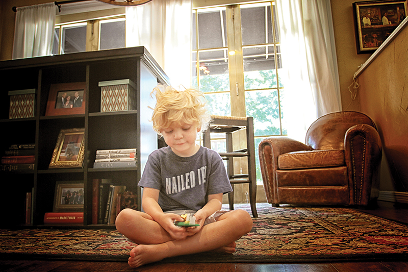 Graham Woodson sits beneath the brass ballroom doors to the Biltmore Hotel, on the spot he was born.