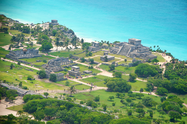 he Mayan city of Tulum sits atop 39-foot cliffs on the Caribbean coast and is surrounded on three sides by an eight-foot thick wall.