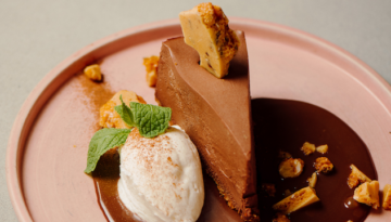 The Mexican hot chocolate cheesecake at Frida's Southwest. The slice of chocolate sits in a pool of melted chocolate.