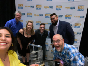 The social media crew for the Oklahoma Department of Wildlife Conservation poses for a selfie with their 2022 Golden Post Award for Best Twitter Presence at the Government Social Media Conference.