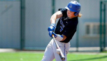 Shortstop Jackson Holliday, playing for the Stillwater High School Pioneers, succesfully swings his bat and hits a baseball right in the barrel of the bat during the day.