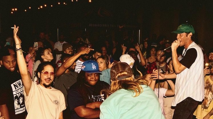 Rapper Josh Sallee performs in front of a packed, vibrant crowd at a MAFF party in Oklahoma City.