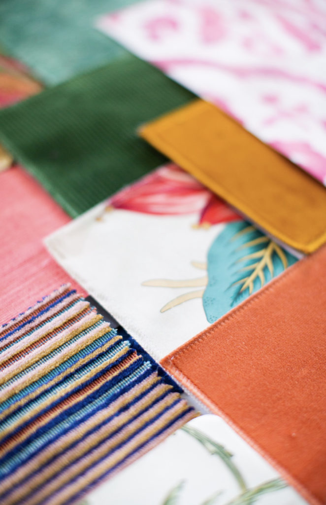 An assortment of patches feature different patterns, such as pastel lines alternating with black lines, a red floral pattern, and splatches of red-orange and rose pink.
