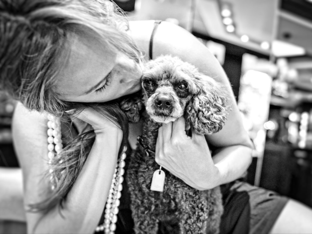 Tiffany Porte Woodruff cuddles her black fluffy poodle Bella.