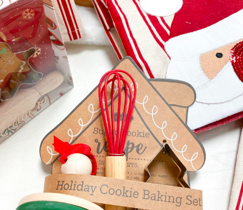A holiday cookie baking set that includes a small whisk.
