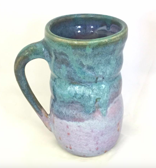 A ceramic mug is glazed in aqua blue.