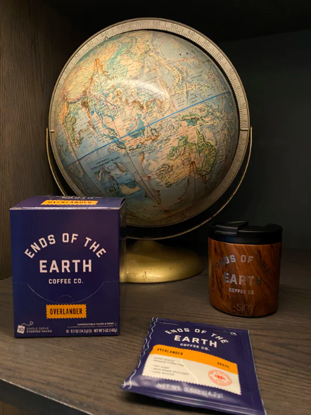 A blue bag of steeped coffee reads "Ends of the Earth Coffee Co."
