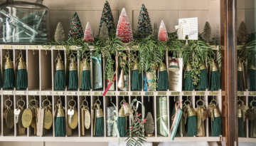 Tiny plastic trees and leaves top a long sectioned keyholder.