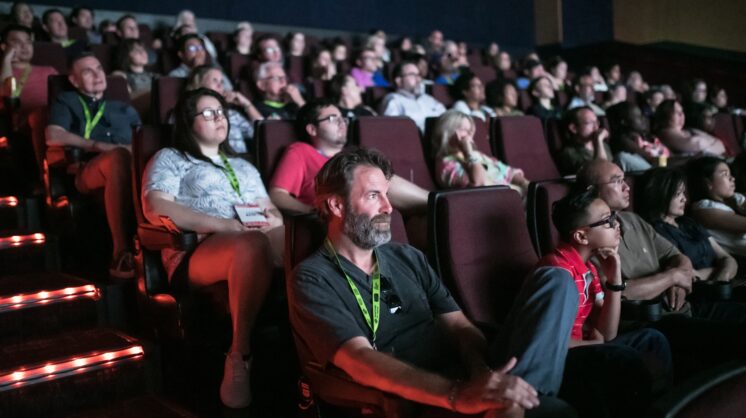 A crowd in dark movie theater watches a film at deadCenter Film Festival in Oklahoma City.