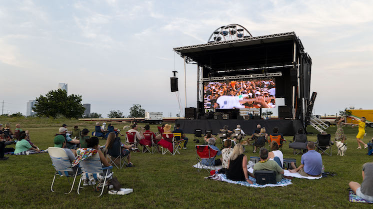 People sitting in lawn chairs and lying on blankets watch a film at Wheeler Park in Oklahoma City during deadCenter Film Festival.