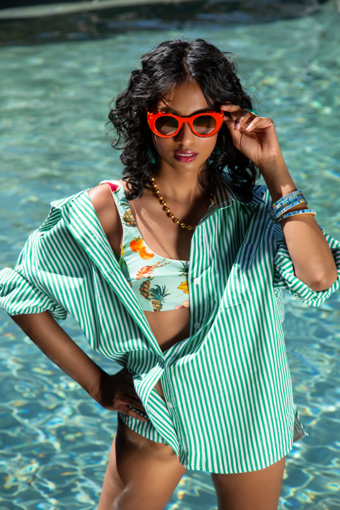 Woman in swimming pool with red sunglasses
