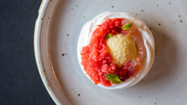 Yuzu olive oil ice cream inside a meringue bowl with strawberry curd, sorrel vinegar gels, white balsamic pickled strawberry, fresh mint and strawberry granita from Nonesuch in OKC.