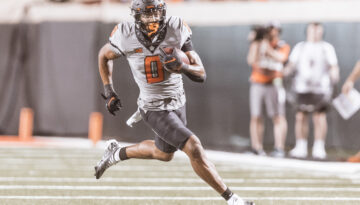 Sophomore OSU running back Ollie Gordon II runs down the field.