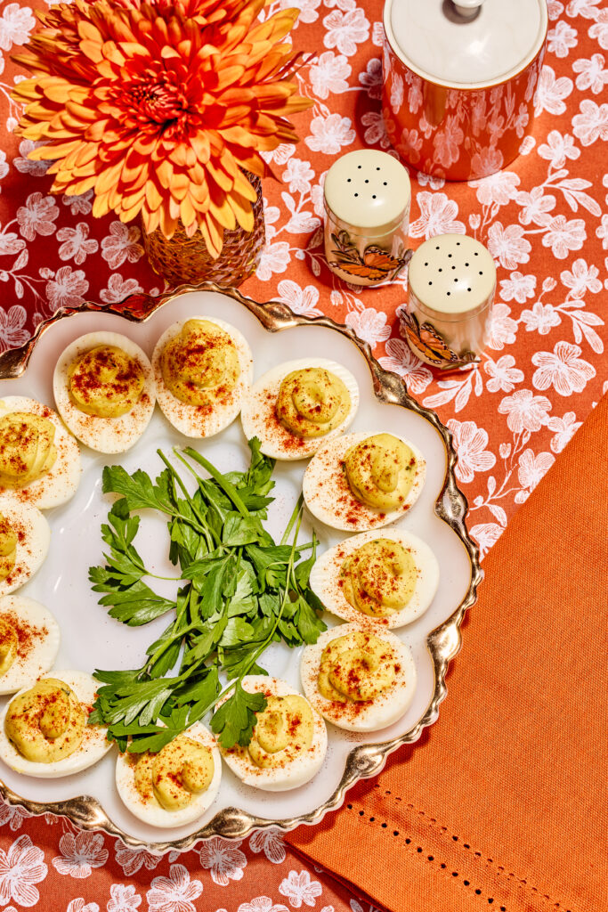 Birds eye view of deviled eggs on orange tablecloth