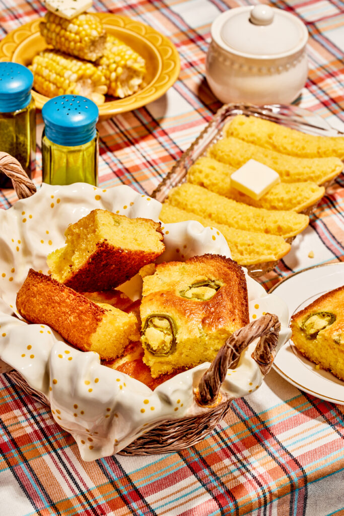 Jalapeno cornbread in a baking dish and ceramic picnic basket