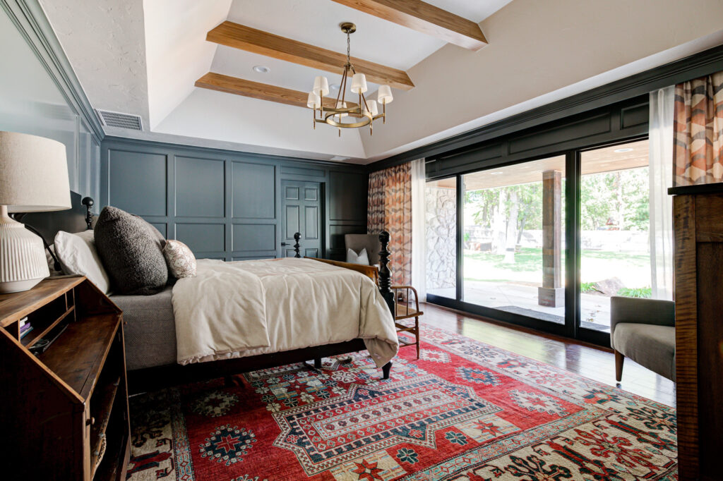 Bedroom with red rug and floor-to-ceiling windows