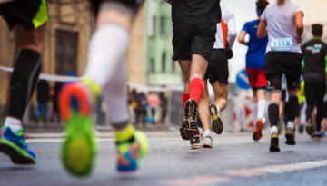 Stock photo of athletes running in a race, taken from the ground behind them