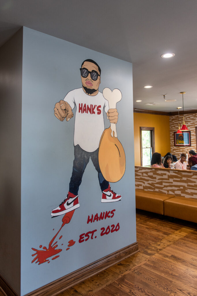 Painted wall in Hank's OKC of Hank holding a turkey leg