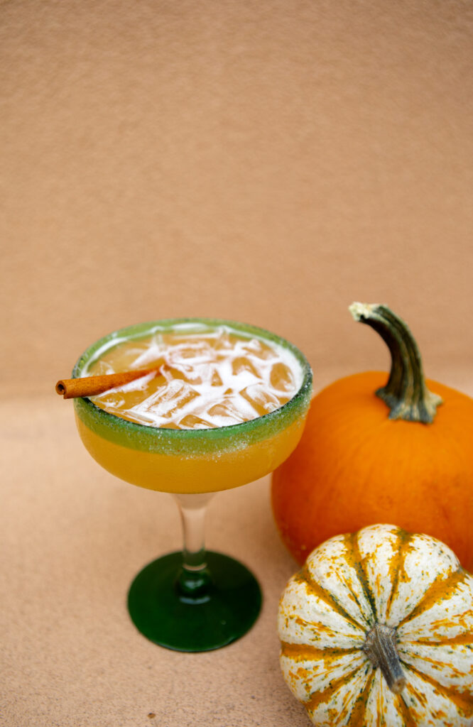 Pumpkin Spice Margarita next to a pumpkin