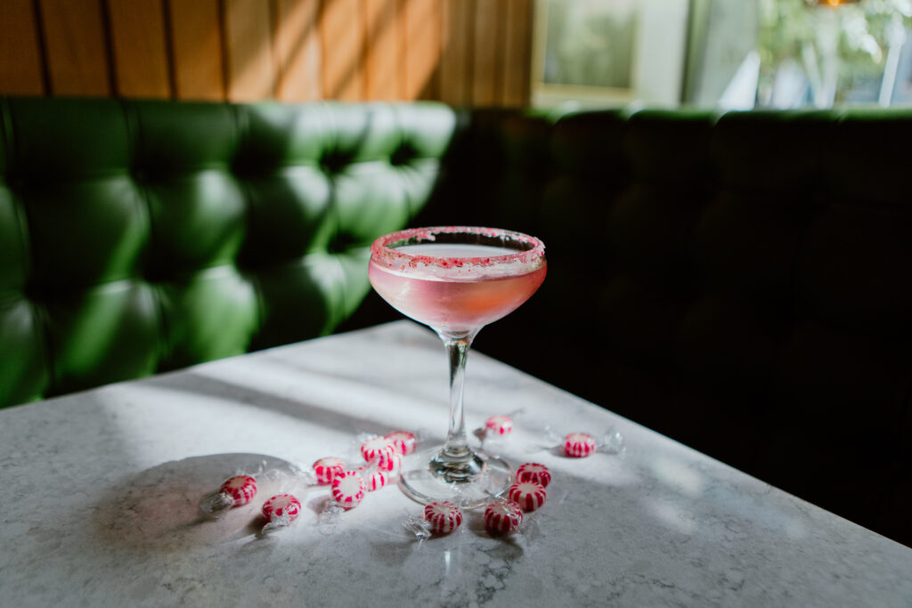 Peppermint Chocolate Martini sitting on a table with peppermints