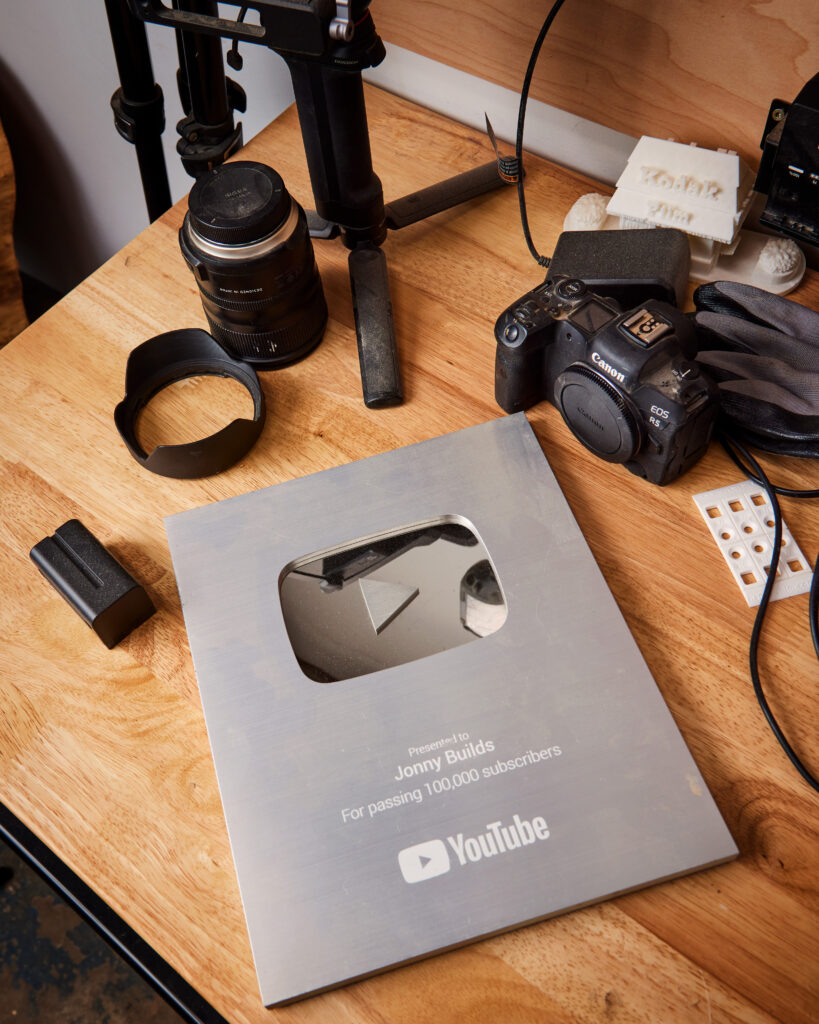 Jonny Builds shows off a YouTube award for gaining over 100,000 subscribers.