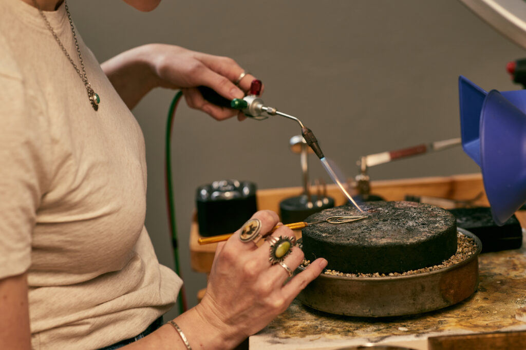 Jewelry maker crafting sterling silver jewelry