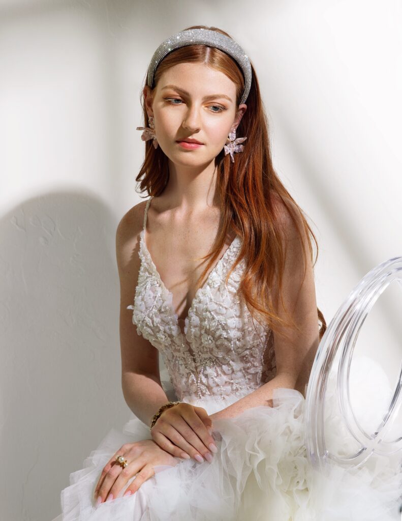Justin Alexander Signature gown withbeaded top from Moliere Bridal; sparkle headband, earrings, ring and bracelet all from Balliets.