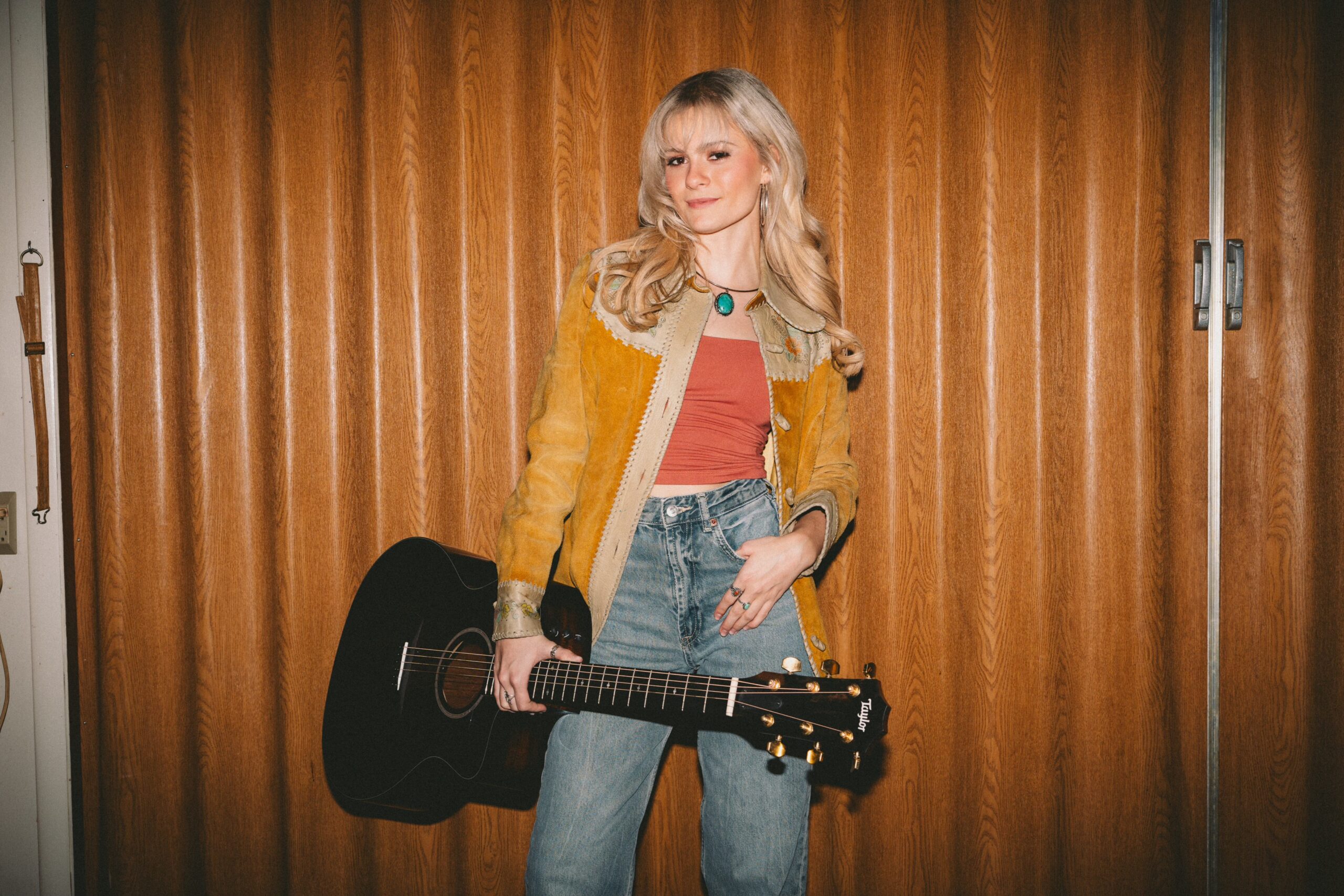 Ventriloquist Darci Lynne Farmer poses with a guitar