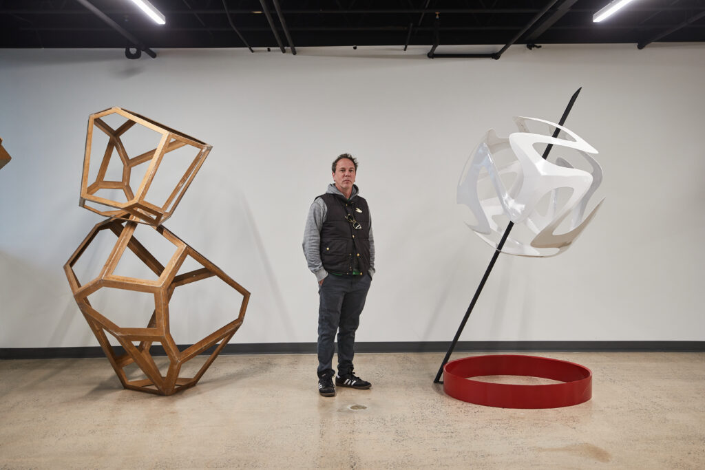 Oklahoma artist Klint Schor with 2 of his sculptures. Photographed by Charlie Neuenschwander.